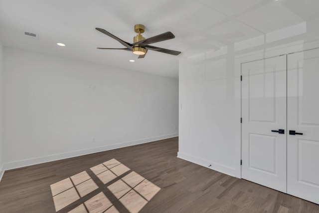 spare room featuring dark hardwood / wood-style flooring and ceiling fan