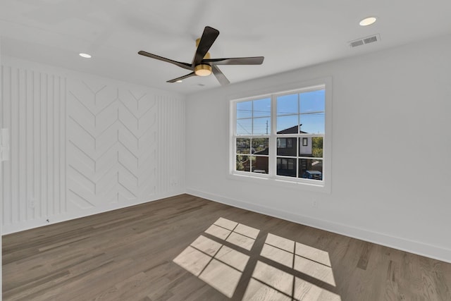 spare room with dark hardwood / wood-style floors and ceiling fan