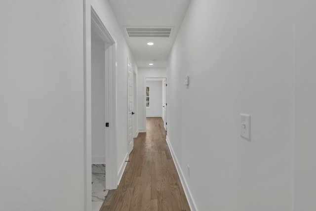 corridor with light hardwood / wood-style floors