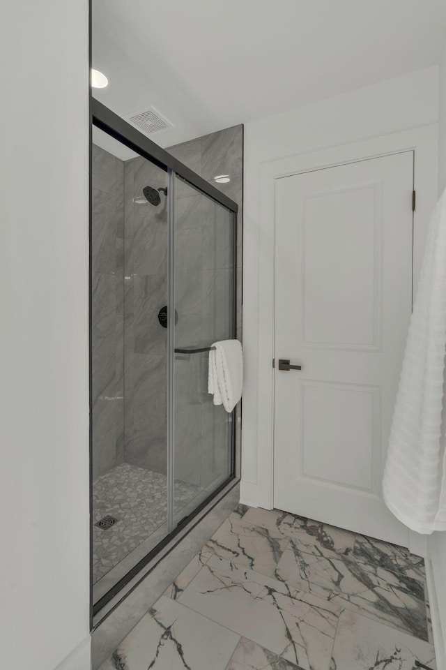 bathroom with a shower with shower door