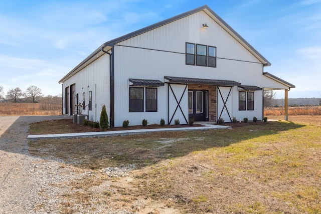 view of front facade with central AC and a front yard