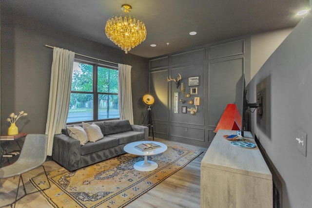 living room with wood-type flooring and a notable chandelier