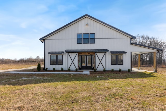 back of house featuring a lawn and french doors