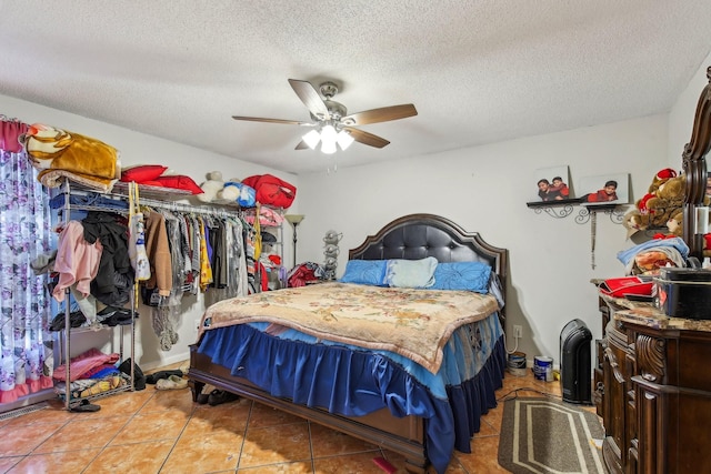 tiled bedroom with ceiling fan and a textured ceiling