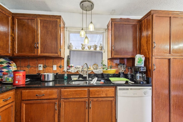 kitchen with sink, hanging light fixtures, a textured ceiling, white dishwasher, and decorative backsplash