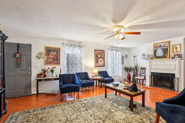 living room with a textured ceiling, tile patterned floors, and ceiling fan