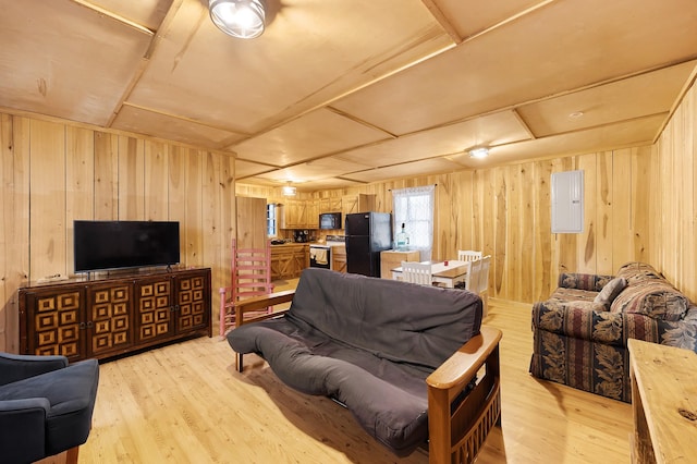 living room with light wood-type flooring and wood walls