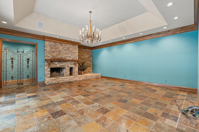 unfurnished living room featuring an inviting chandelier, a fireplace, and a raised ceiling