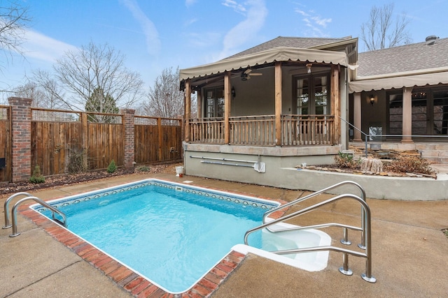 view of swimming pool with ceiling fan and french doors