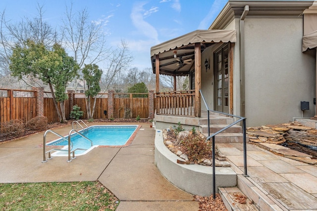 view of pool with a patio and ceiling fan