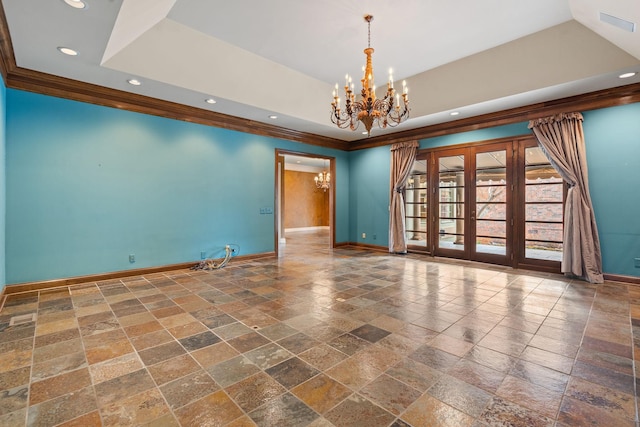 unfurnished room featuring french doors, ornamental molding, a raised ceiling, and a notable chandelier