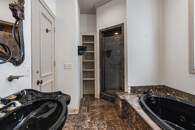 bathroom featuring ornamental molding, plus walk in shower, and sink