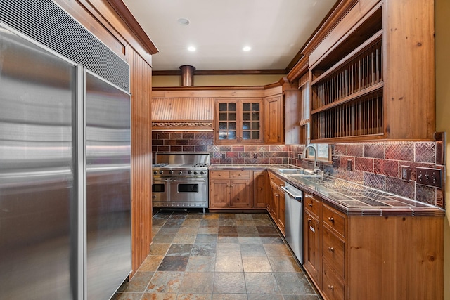 kitchen with high quality appliances, sink, and decorative backsplash