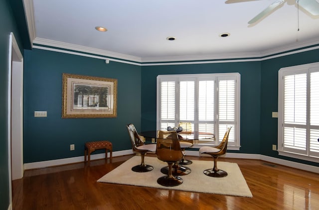 dining area with hardwood / wood-style flooring, ornamental molding, and ceiling fan