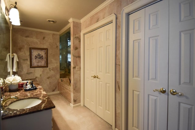 bathroom with vanity, ornamental molding, and tiled shower / bath