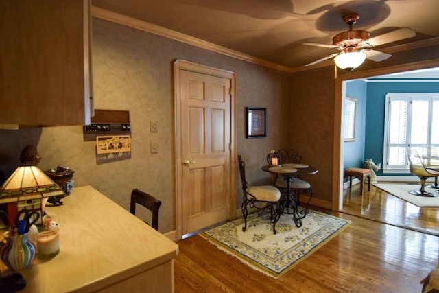 dining area with crown molding, hardwood / wood-style flooring, and ceiling fan