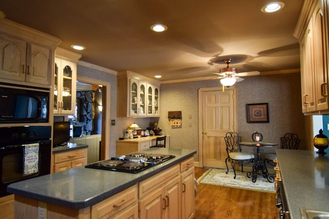 kitchen featuring dark wood-type flooring, ceiling fan, ornamental molding, black appliances, and light brown cabinetry