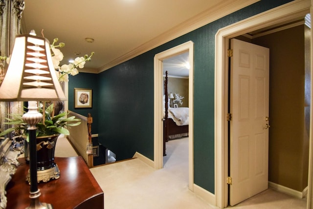 hallway featuring crown molding and light carpet