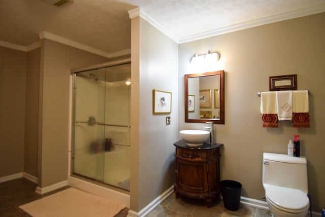 bathroom with crown molding, vanity, toilet, and an enclosed shower