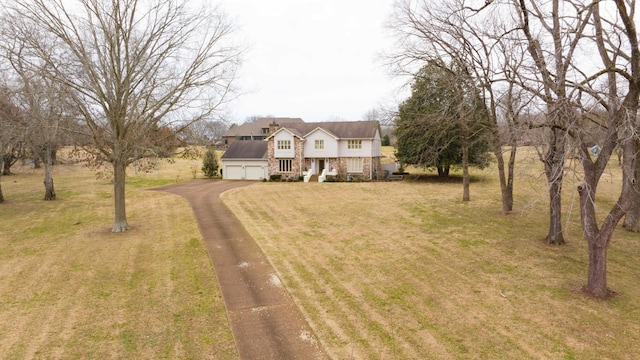 view of front of property with a garage, covered porch, and a front lawn