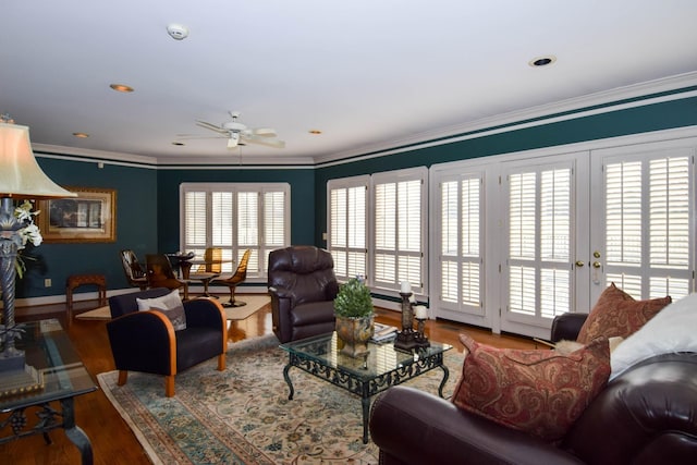 living room with crown molding, hardwood / wood-style flooring, french doors, and ceiling fan