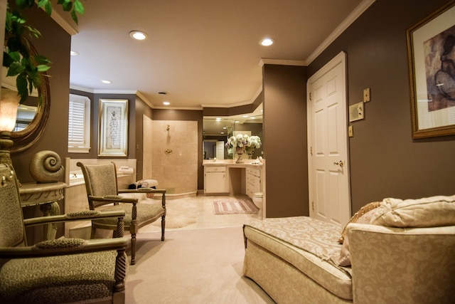 sitting room with ornamental molding and light colored carpet