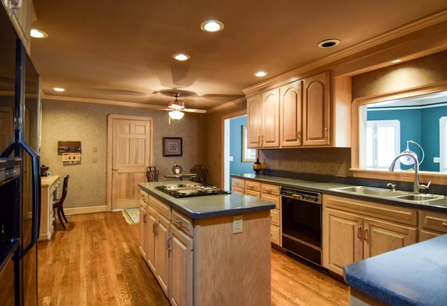 kitchen with sink, crown molding, black dishwasher, and a kitchen island