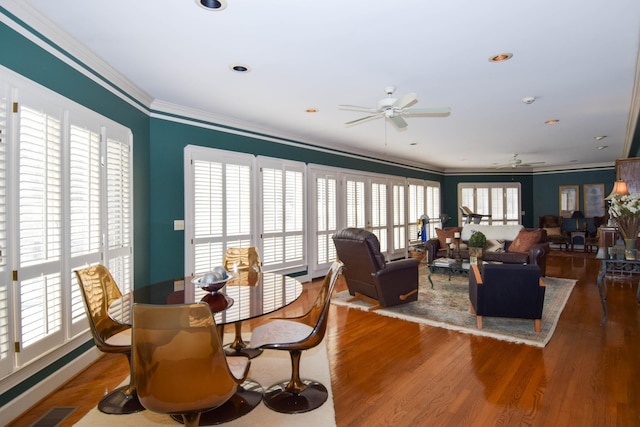 dining room with hardwood / wood-style flooring, a wealth of natural light, ornamental molding, and ceiling fan