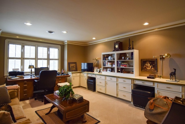 office space featuring ornamental molding, built in desk, and light carpet