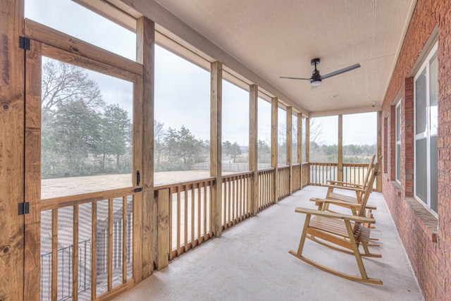 sunroom / solarium featuring ceiling fan