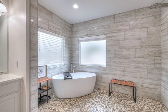 bathroom with vanity and a bathtub