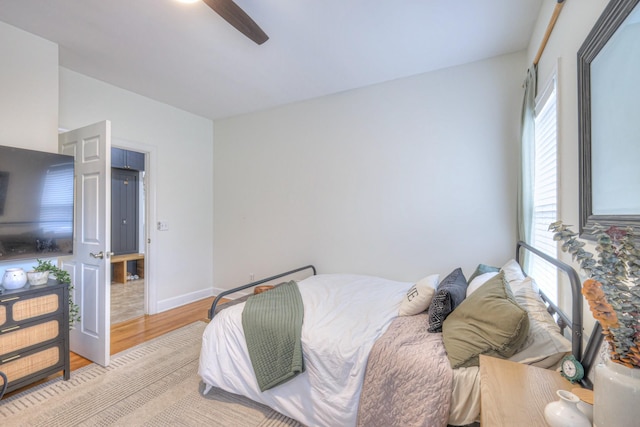 bedroom with ceiling fan and light wood-type flooring