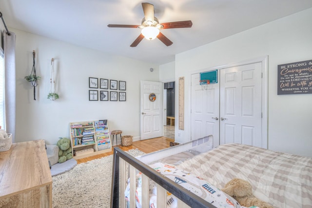 bedroom with wood-type flooring, a closet, and ceiling fan