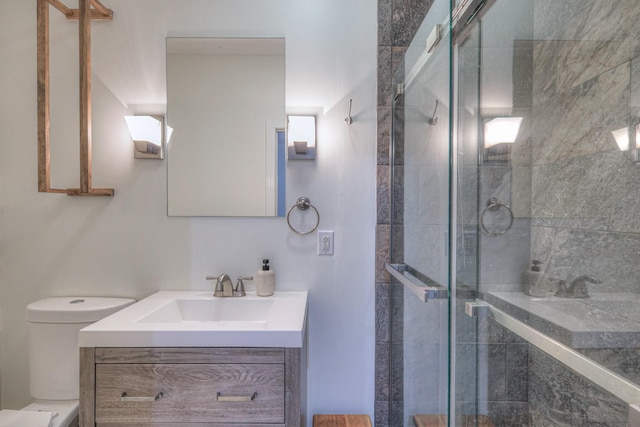 bathroom with vanity, toilet, and walk in shower