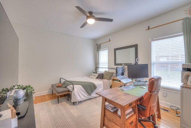 bedroom with light hardwood / wood-style floors and ceiling fan