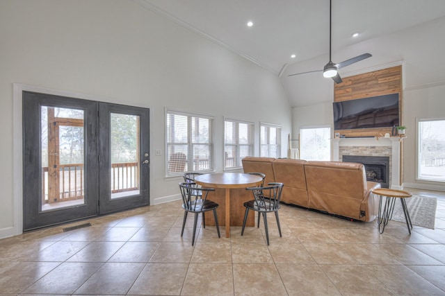 dining space featuring light tile patterned floors, high vaulted ceiling, and ceiling fan