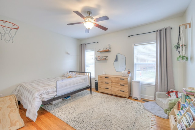 bedroom with hardwood / wood-style flooring and ceiling fan