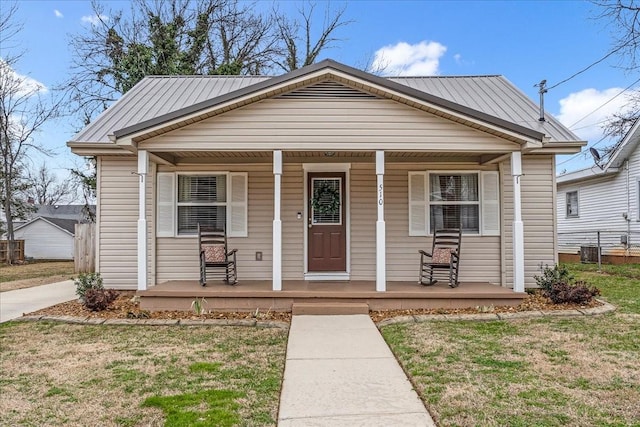 bungalow-style home with a porch and a front lawn