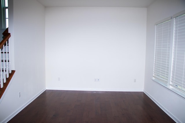 spare room with dark hardwood / wood-style flooring