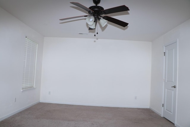 carpeted spare room featuring ceiling fan