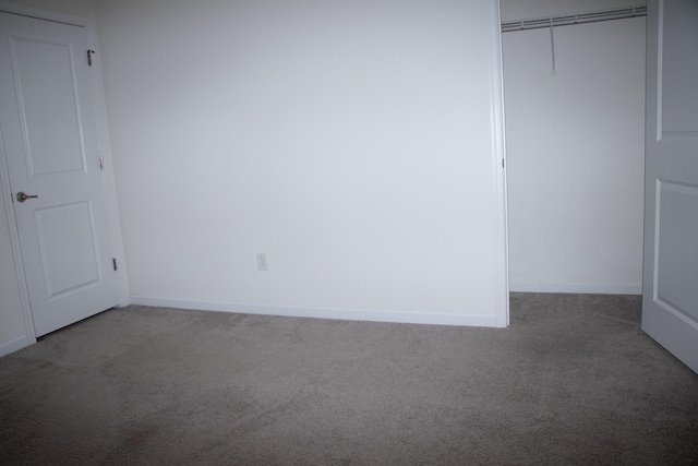 unfurnished bedroom with carpet floors and a closet