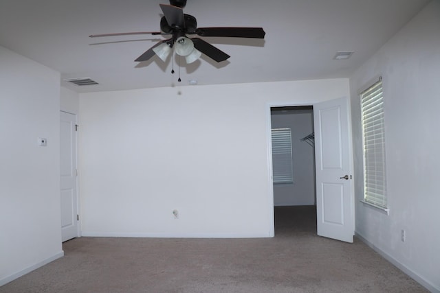 unfurnished bedroom with light carpet and ceiling fan