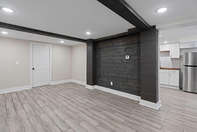 unfurnished living room with recessed lighting, beam ceiling, baseboards, and wood tiled floor