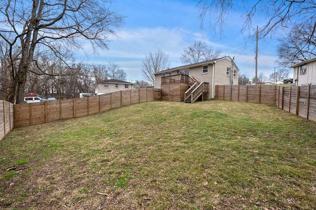 view of yard featuring a fenced backyard, stairs, and a deck