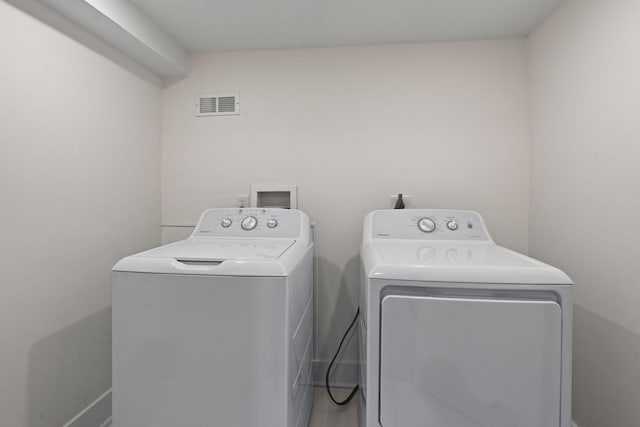 laundry room with washer and dryer, laundry area, and visible vents