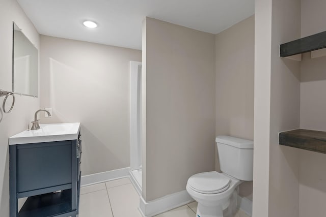 full bath featuring toilet, vanity, baseboards, and tile patterned floors