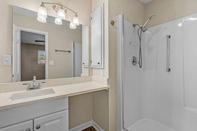 bathroom with vanity and a shower