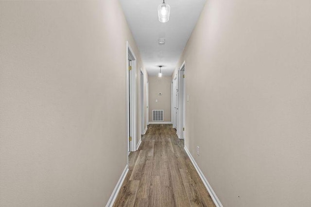 hall with hardwood / wood-style flooring