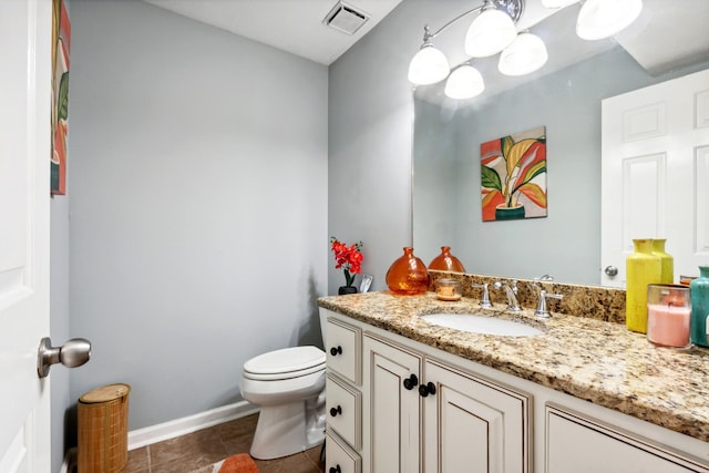 bathroom featuring vanity, tile patterned flooring, and toilet