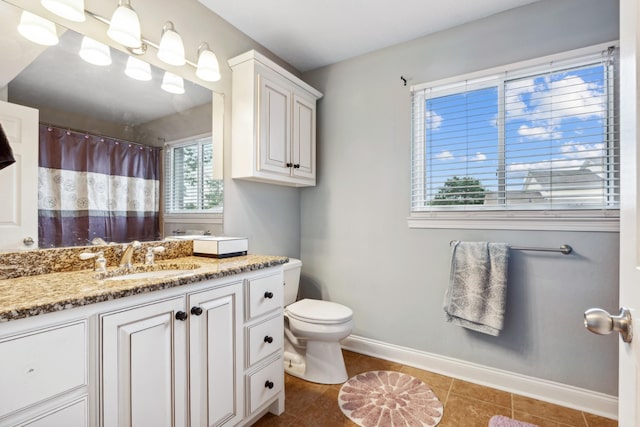 bathroom featuring vanity, toilet, and tile patterned flooring